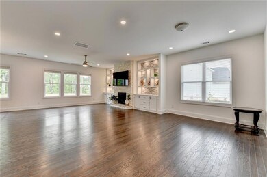 Unfurnished living room featuring dark wood-style 