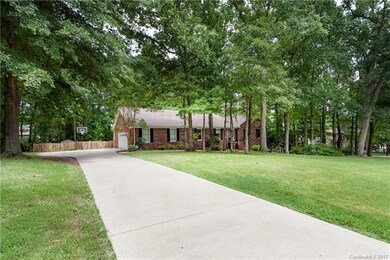 Nestled in the trees, this brick ranch with full b
