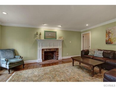 Family Room with custom mantle, hardwood, and crow