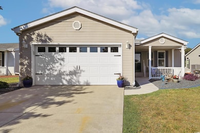 Ranch-style home with a porch, concrete driveway, 