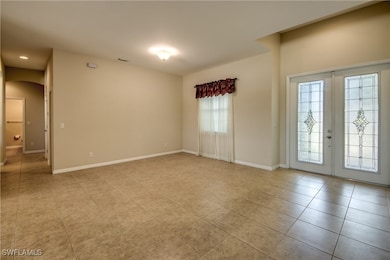 Spare room featuring arched walkways, light tile p