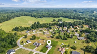 View of property location with a heavily wooded area and nearby suburban area