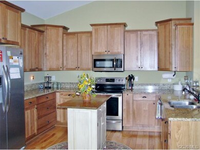Spacious kitchen with granite tops, shaker style cabinets and eat in area.  Island is a furniture piece.