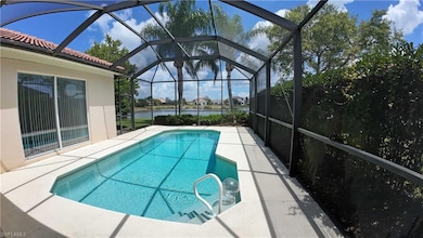 Outdoor pool featuring a patio area, a water view, and a lanai