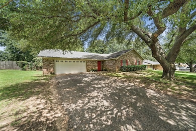 Single story home featuring a garage and a front l