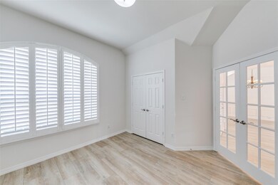 Office/study featuring a chandelier, light hardwood / wood-style flooring, and french doors