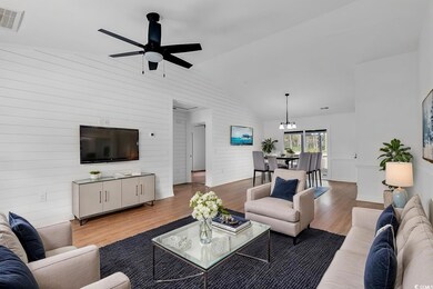 Living room featuring ceiling fan, wood-type floor