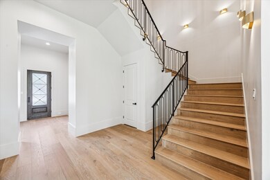 Stairway with sconces lining the walls.