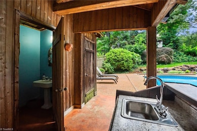 Pool house with bathroom and wet bar.