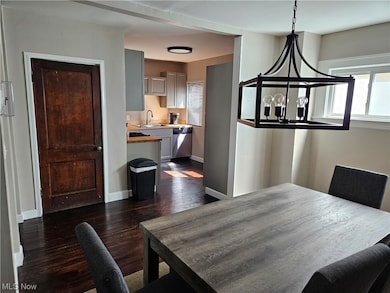 Hardwood floored dining room featuring a notable chandelier