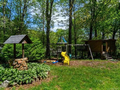 A decorative well surrounded by gorgeous hostas, c