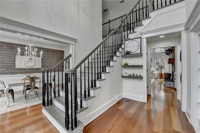 Stairs featuring baseboards, wood finished floors,
