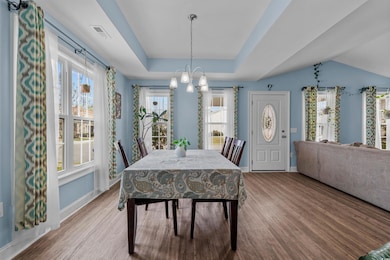 Dining area featuring light wood-type flooring, ba