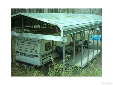 Exterior Front. Metal roof carport over Jayco