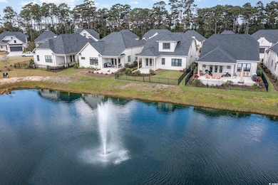 Birds eye view of property with a water view