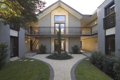 Rear view of house featuring a yard and a balcony