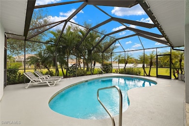 View of pool featuring a patio and glass enclosure