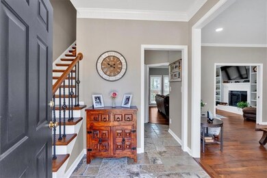 Foyer featuring baseboards, stairs, ornamental mol