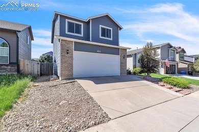 View of front of home with brick siding, concrete driveway, and a garage