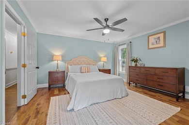 Primary bedroom with great natural light. Notice the ceiling fans.
