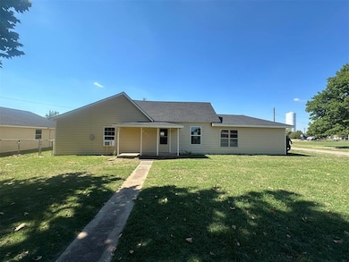 Back of house featuring a yard