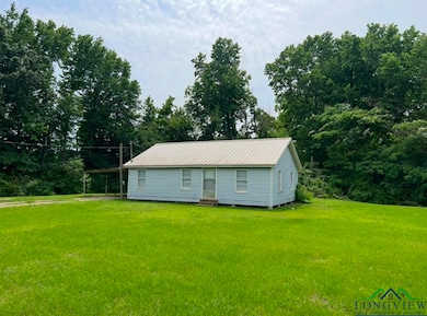 View of home with a yard