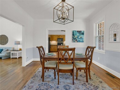 Dining area with wood-type flooring, a chandelier,