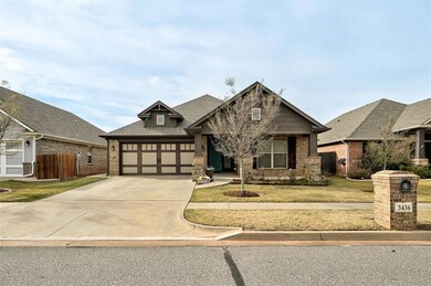 View of front of home with a front lawn and a gara