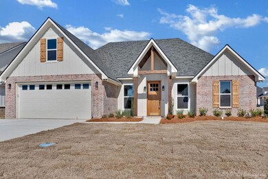 View of front of home with a garage, brick siding,