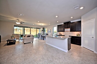 Grand Family Room is open and flows so gently into your Gourmet Kitchen and Casual Dining!  Wait till you open that Huge Disappearing Sliding Glass Door to allow the Outside come inside!  Stunning feature that you will love!