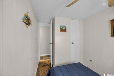 Unfurnished bedroom featuring visible vents, wood 