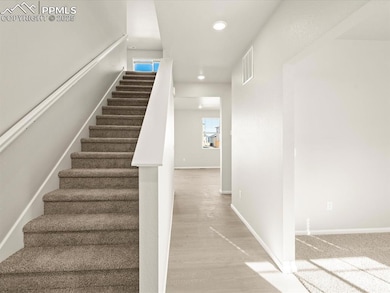 Staircase with hardwood / wood-style flooring