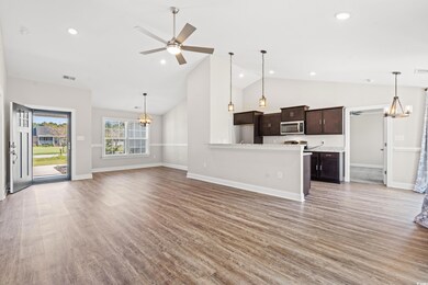 Unfurnished living room featuring ceiling fan with
