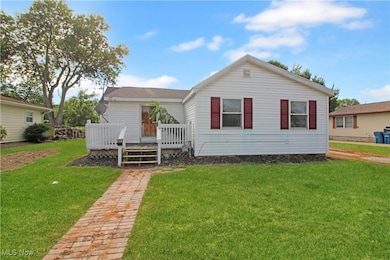 View of front of house featuring a front yard and a deck