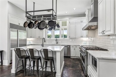 Renovated kitchen with quartz counters and plentif