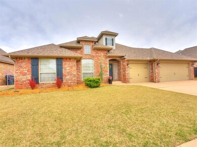 View of front of home with a front lawn and a gara