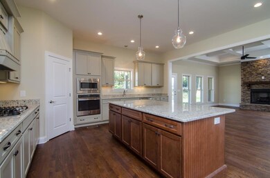 View of the kitchen looking into the Family room.  Extra large pantry is located in the corner. 