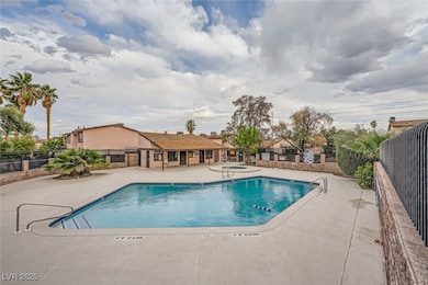 Community pool with fence and a patio