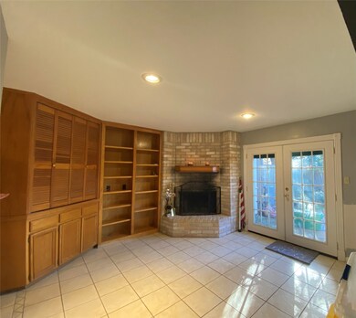 Living area with fireplace and built in shelving