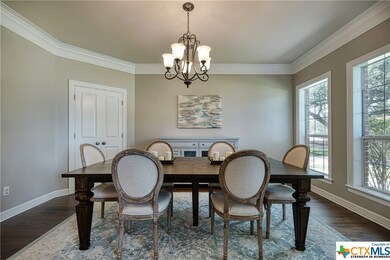 Elegant formal dining room with large picture windows looking out to the Tree lined front yard.  Enjoy the visits from the neighborhood deer grazing in the front yard.