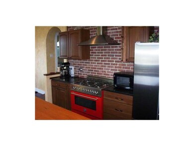 Kitchen. The 6 burner red stove is an upbeat featu
