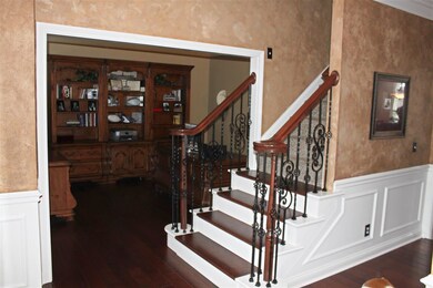 The Foyer offers a staircase with wrought iron det