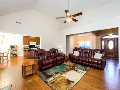 Another view of family room with ceiling fan and v