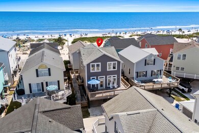 Aerial view of residential area featuring waterfront with a beach