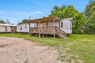 This photo shows a modest mobile home with a woode
