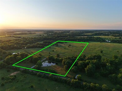 Aerial view of sparsely populated area featuring property parcel outlined and a nearby body of water