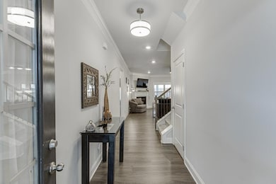 Corridor featuring ornamental molding, stairway, d