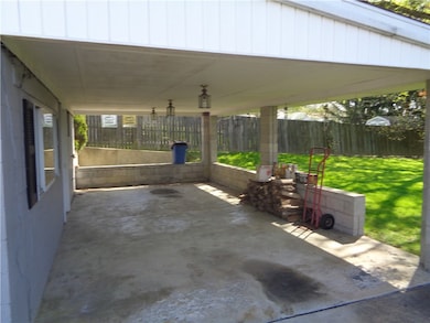Rear of home with covered back porch  and concrete