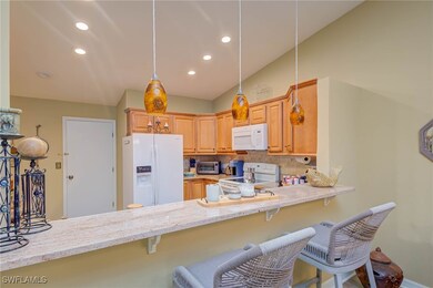 Kitchen featuring white appliances, decorative bac