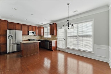 Kitchen featuring a chandelier, decorative backspl
